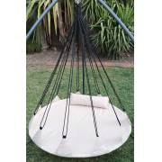 Beige open hangout on a tripod stand in a garden