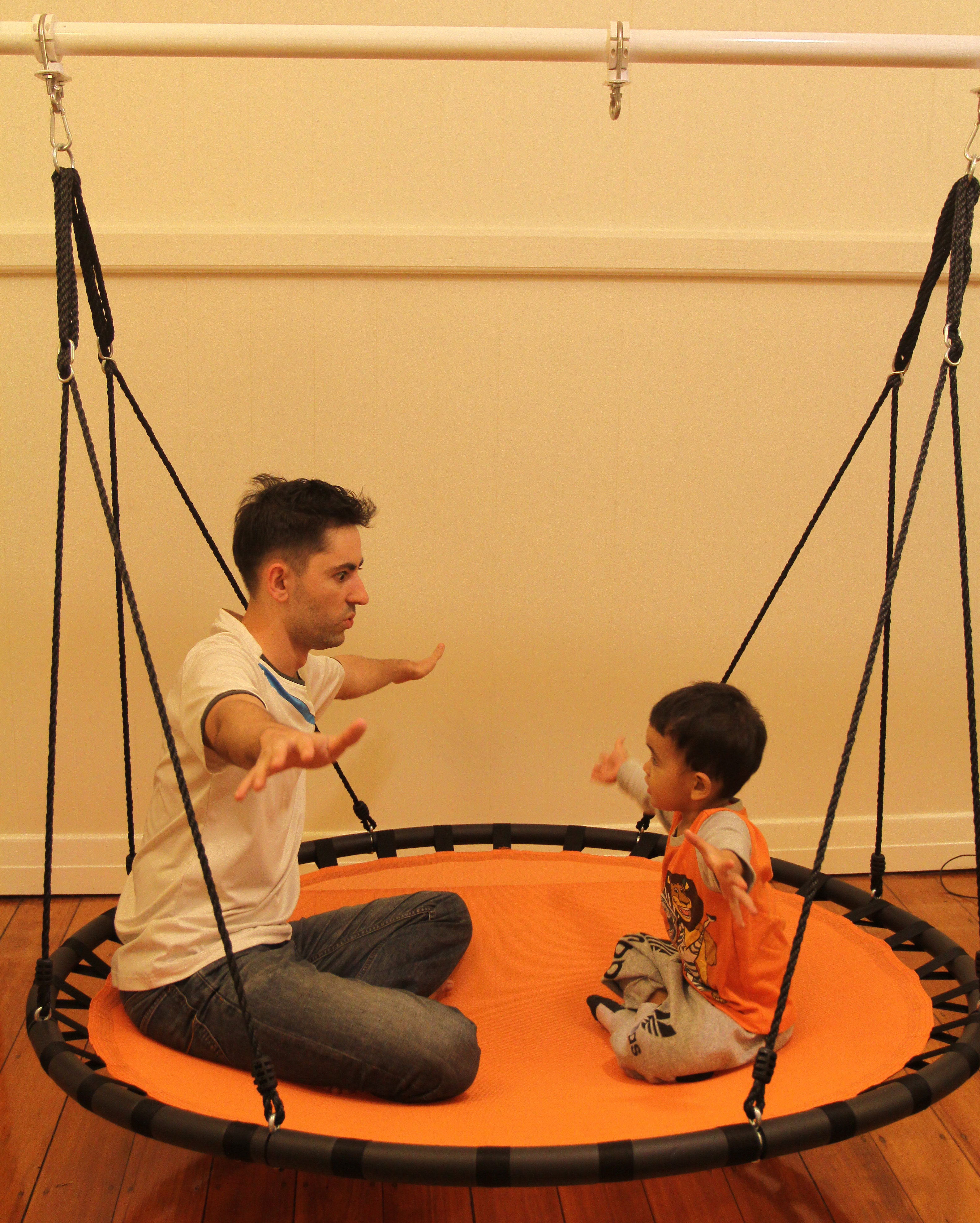 150cm orange mat nest swing in motion on a swing set stand
