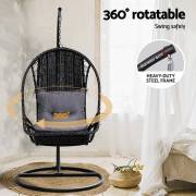 Black wicker egg chair indoors, showing that it turns a full circle on the 4cm steel frame