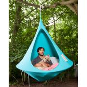 Man and dog inside a turquoise Cacoon single hung from a tree