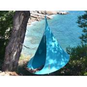 Turquoise Cacoon single hung from a tree above the sea