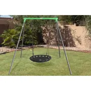 The steel swing set with its nest swing on a backyard lawn