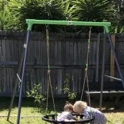 Customer photo of two toddlers at the nest swing of the steel swing set