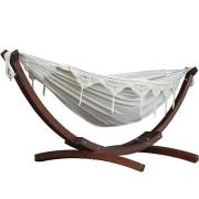Beige cotton hammock with crochet fringe on a dark wood arc stand, on white
