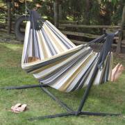 Beige and grey striped hammock on its steel stand on a lawn
