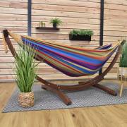 Mixed bright colours hammock on its wood arc stand on a covered patio with a rug