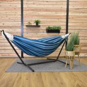 Mixed blues hammock on its steel stand on a covered patio with a rug