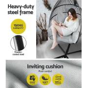 Woman reading in the grey open weave egg chair, with the 150kg capacity and powder coated steel frame noted