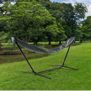 Hammock in its grey sleeve on a steel stand on a lawn