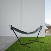 Hammock in its grey sleeve on a steel stand on a patio