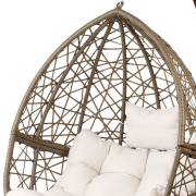 Close up of the hand woven latte rattan lattice at the top of the pod, with the cream pillow and cushion