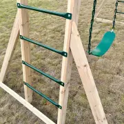 Green steel ladder rungs on a timber leg, with a belt swing beside it