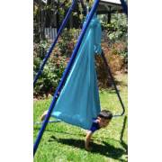 Boy swinging face down in the teal wrap swing on the stand