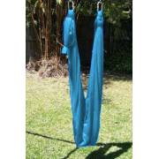 Medium teal wrap swing hanging empty from the swing set stand