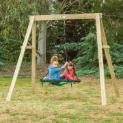 Two girls sharing the web swing on the timber frame on a lawn