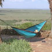 Turquoise parachute hammock hung at a lookout over a valley