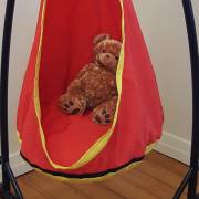 Teddy bears inside the red and yellow pod chair