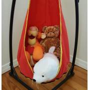 Close up of soft toys in the red and yellow pod chair on the stand