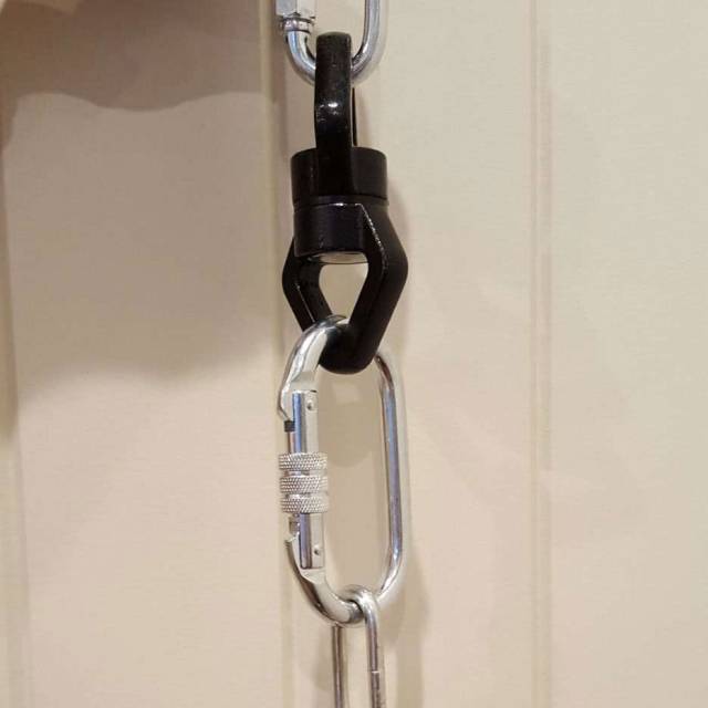 Swivel and carabiners fitted between the hanging chain and the swing