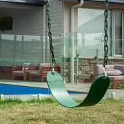 Empty green belt swing seat hanging on coated chains above the grass