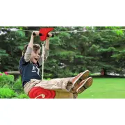 Boy riding the flying fox on the red disc seat