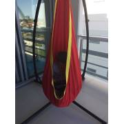 Red and yellow pod chair on the X stand on a balcony