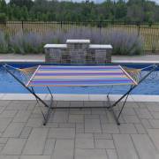 Multi colour spreader bar hammock on the 3.7m stand beside a pool, seen from the end