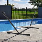 Three beam steel hammock stand beside a pool